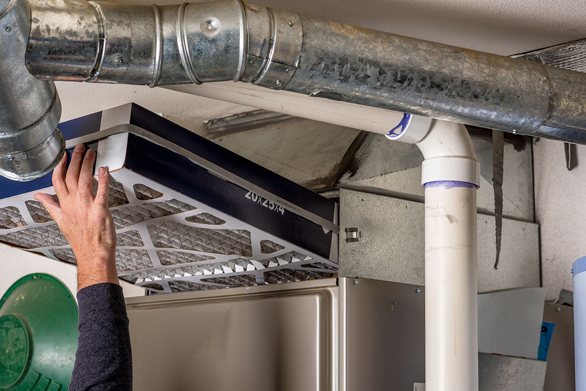 Technician inspecting furnace filters