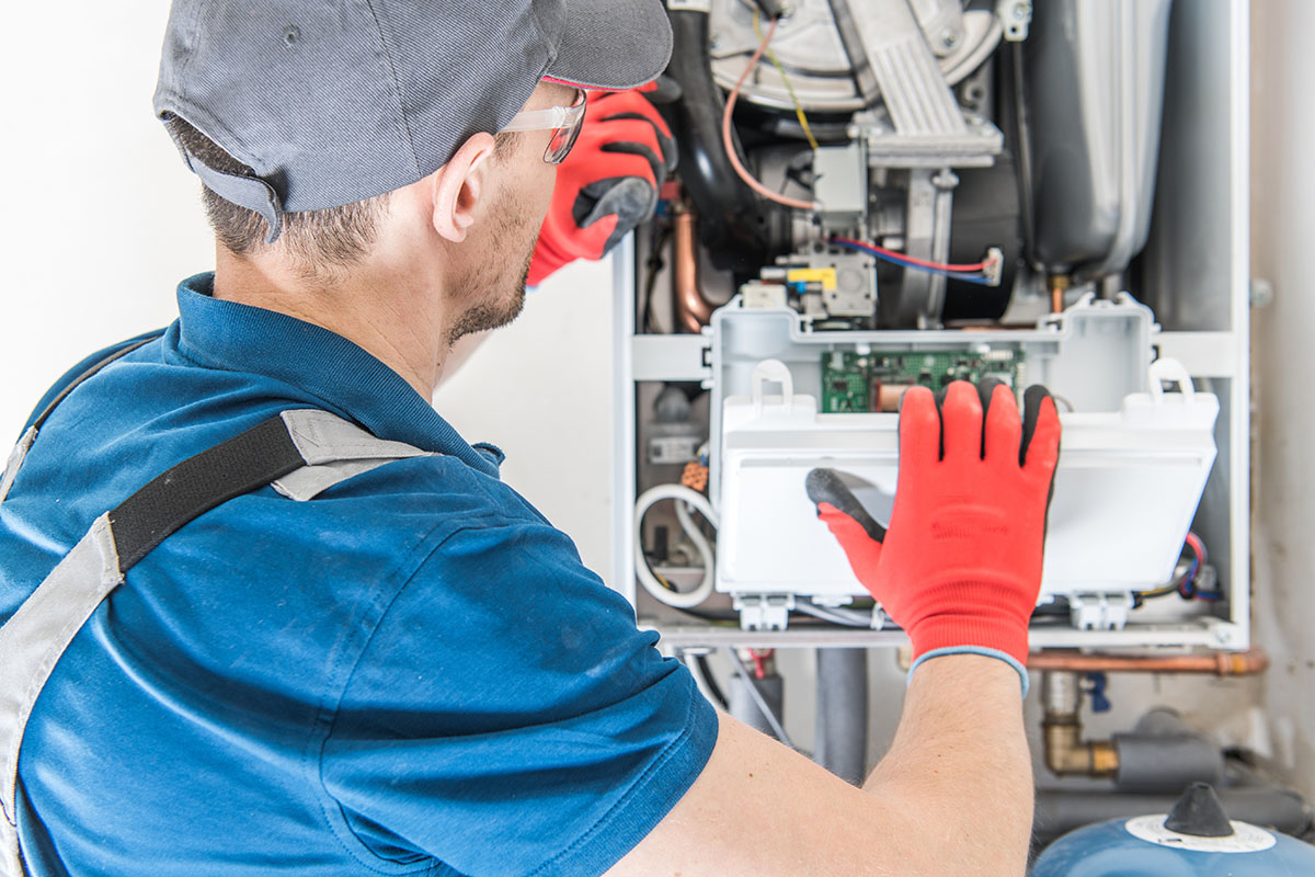 Technician repairing furnace